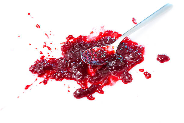 istock Spoon resting in a splattered blob of sour cherry jam 118315989