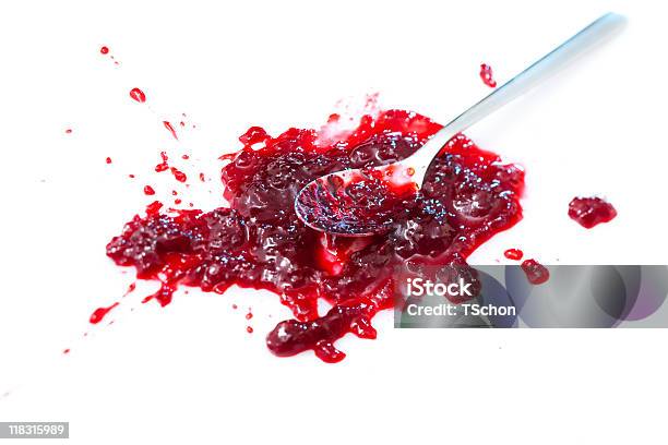 Spoon Resting In A Splattered Blob Of Sour Cherry Jam Stock Photo - Download Image Now