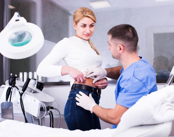istock cosmetologist examining female body before procedure 1183159971