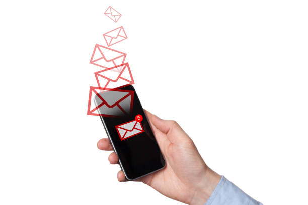 istock A new message received on mobile phone. Red envelopes as incoming or outgoing messages. Man's Hand holding a smartphone. White background 1183159972