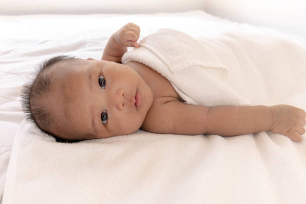 istock A newborn baby is lying on a white mattress 1183161101