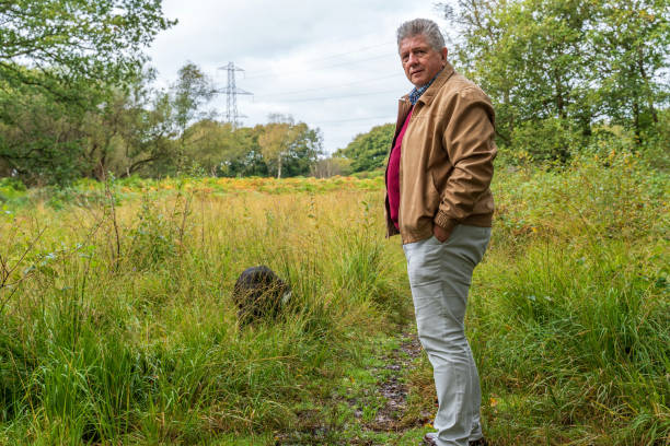 istock Active senior man with dog in countryside 1183161473