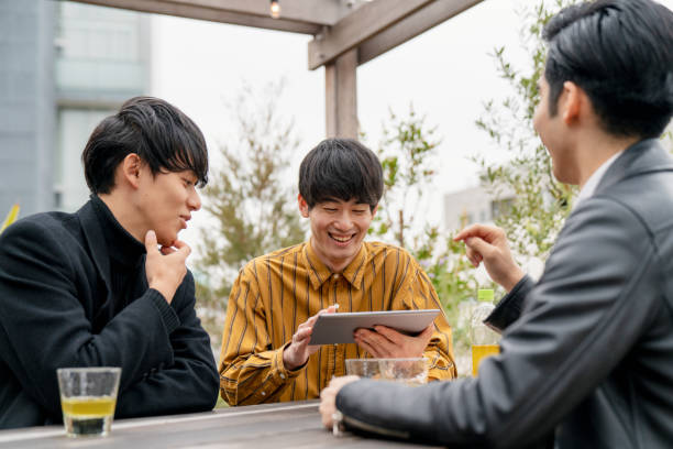 istock Group of young men meeting outdoors and looking at a digital tablet 1183163085