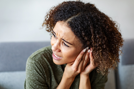 Biracial young woman with an ear ache