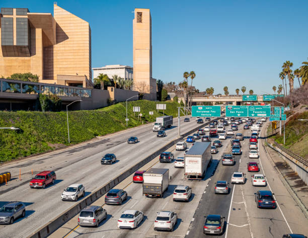 Traffic on the Hollywood Freeway in Los Angeles Los Angeles, USA - Congested traffic on the northbound carriageway of the Hollywood Freeway 101, passing the Cathedral of Our Lady of the Angels. los angeles traffic jam stock pictures, royalty-free photos & images