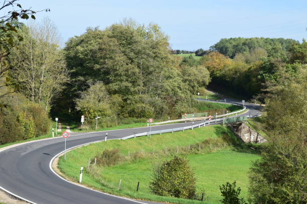 istock narrow curvy country road, Eifel 1183165686