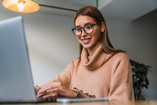istock Young girl working on laptop while sitting at coffee shop 1183166026
