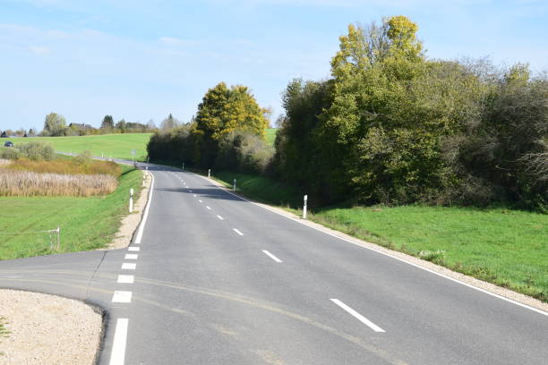 istock straight country road in autumn, Eifel 1183166223