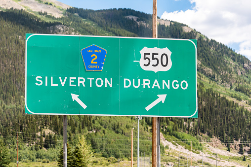 Directional sign post for on highway road 550 for Silverton or Durango in Colorado summer