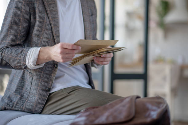 istock Businessman reading his post after going to the post office 1183171382
