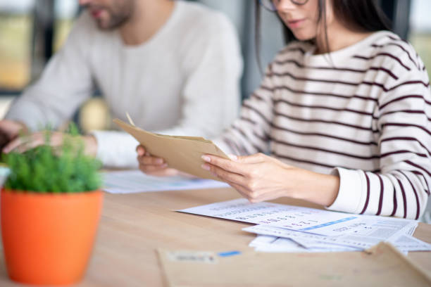 istock Close up of wife holding envelopes with letters 1183171390