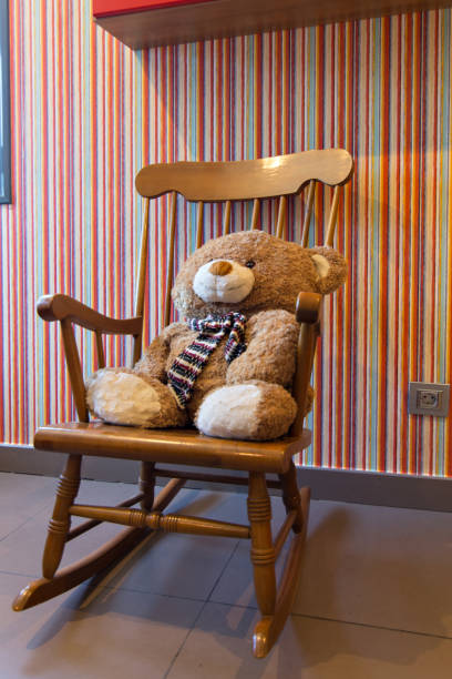 istock Teddy bear sitting in a rocking chair. 1183172217