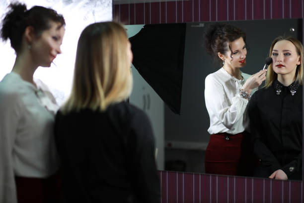 istock Young girl with a make-up artist 1183173078