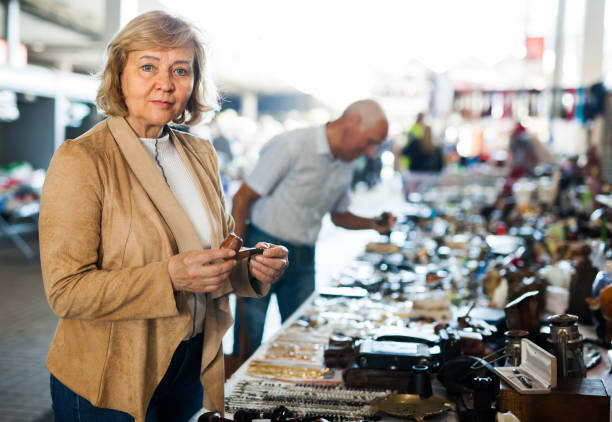 istock Mature couple choose smoking pipe on flea market 1183173093