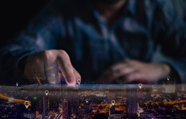 istock Double exposure of man hand using digital tablet searching target place on night cityscape while working in office. 1183174221
