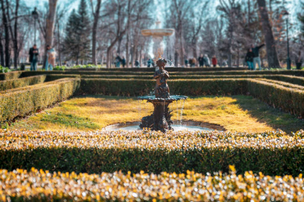 Source of the Retiro Park, surrounded by gardens in autumn. Unrecognizable couples walking. Madrid, Spain.