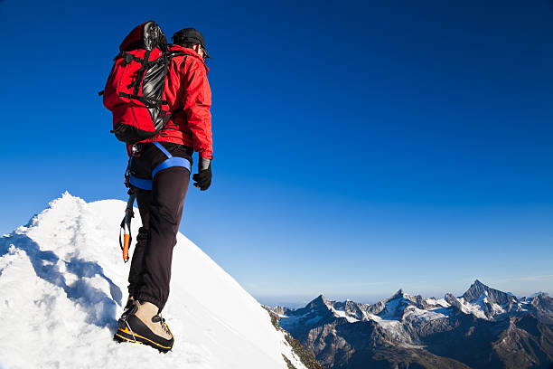 istock A climber on top of a snowy mountain 118317633