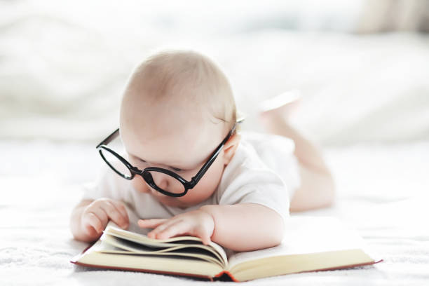 istock A newborn baby is lying on a soft bed in glasses. 1183179949
