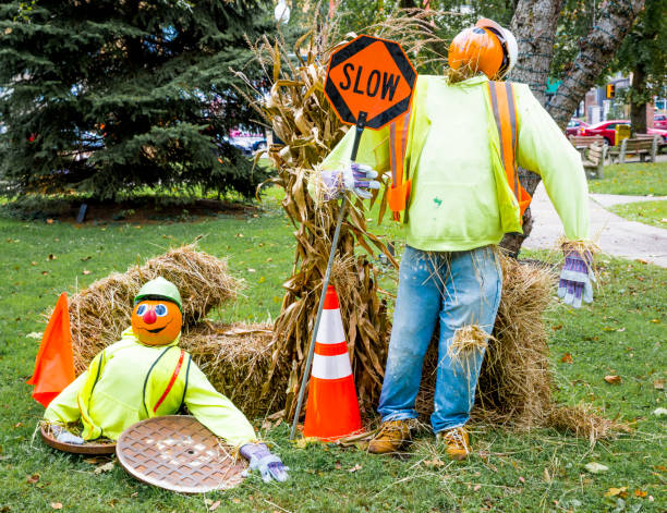 Halloween--Pumpkin Head Street Workers With SLOW Sign stock photo