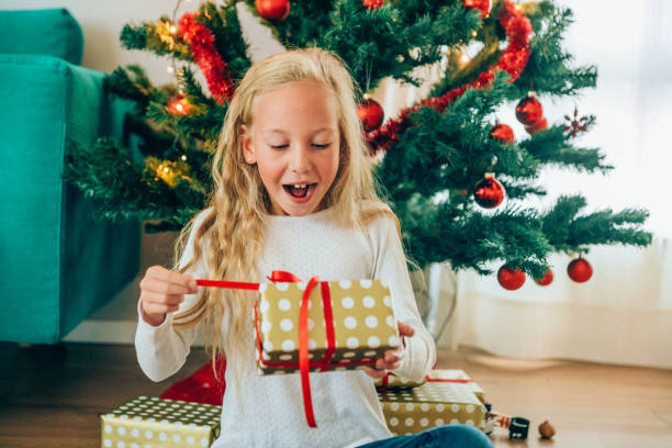 istock Excited girl opening Christmas present. 1183191730