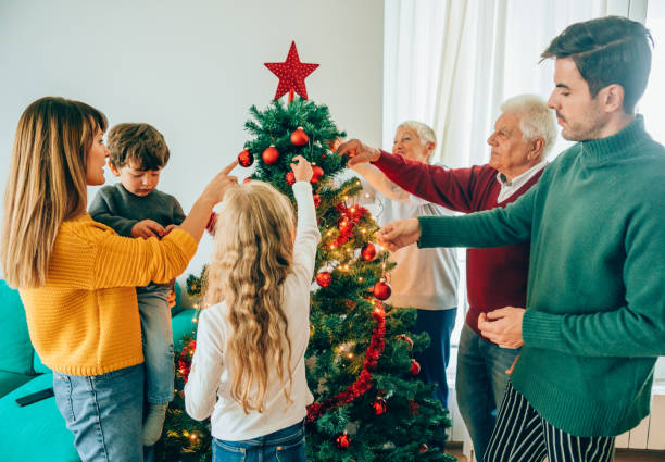 istock Multi-generation family decorating the Christmas tree together 1183191759