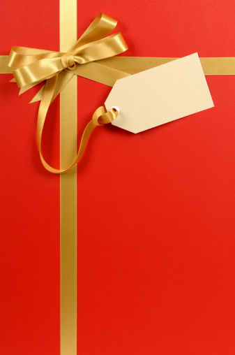 Red and gold gift with blank tag or label.  I have one of the largest collections of gift ribbons available at iStock. If you’d like see my complete collection please CLICK HERE 
