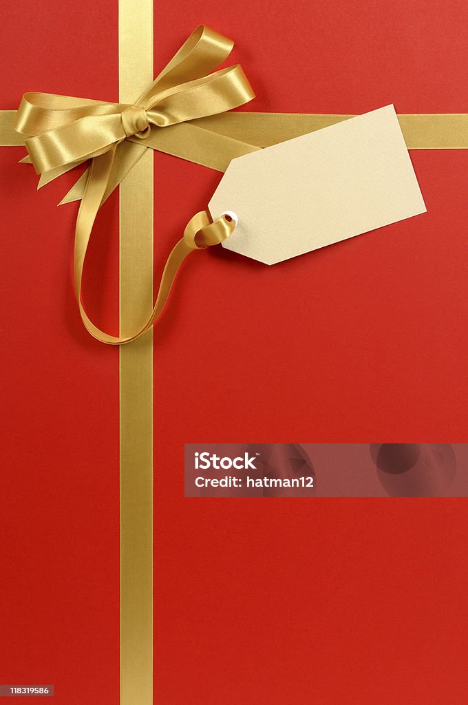 Red and gold gift with tag Red and gold gift with blank tag or label.  I have one of the largest collections of gift ribbons available at iStock. If you’d like see my complete collection please CLICK HERE  Christmas Present Stock Photo