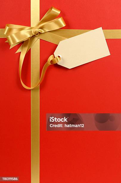 Red And Gold Gift With Tag Stock Photo - Download Image Now - Christmas Present, Label, Tied Bow