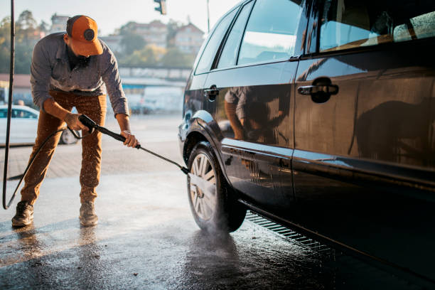 istock Handsome man washing car 1183197522