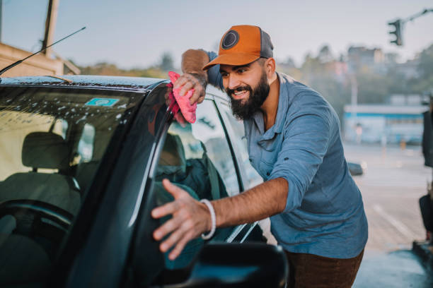 istock Handsome man washing car 1183198615