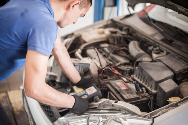 istock Car mechanic checking and testing automotive accumulator with battery tester 1183199872