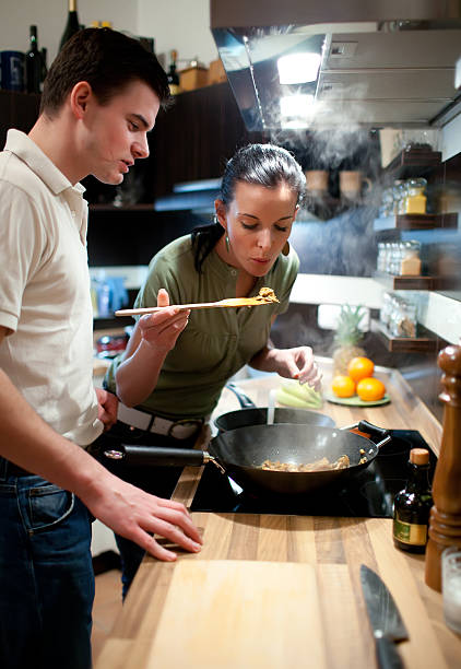 istock Young couple preparing lunch in kitchen 118320093