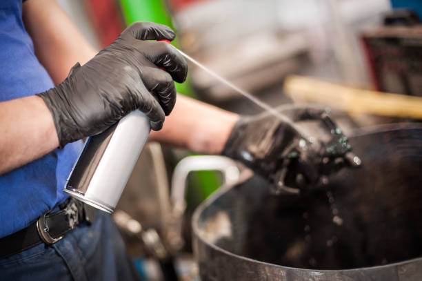 istock Car master mechanic repairer lubricates screws with machine cleaner spray 1183202503