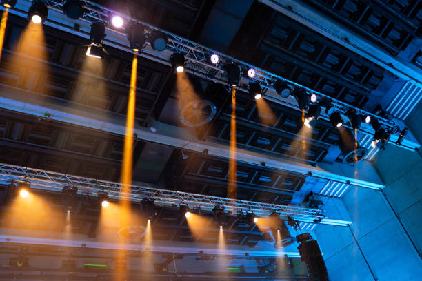 istock Stage lights. Orange and blue spot lights on steel construction. Lightning equipment. 1183202869