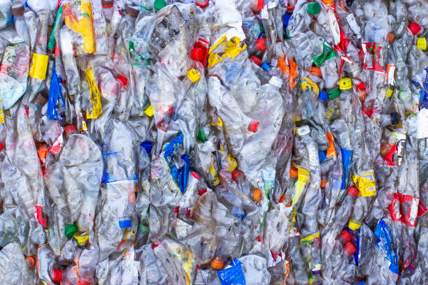 istock Recycling concept. The problem of ecology, environmental pollution. Background of plastic bottles transparent blue ne 1183207070