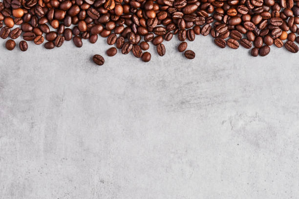 istock Coffee beans isolated on a grey concrete background. 1183208996