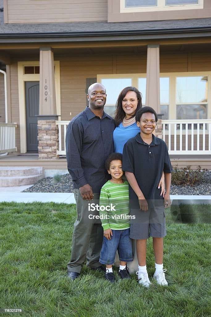 Parents and kids taking picture in front of home Family in front of home House Stock Photo