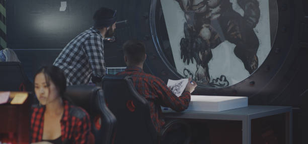 istock Graphic designers discussing video game art 1183215591