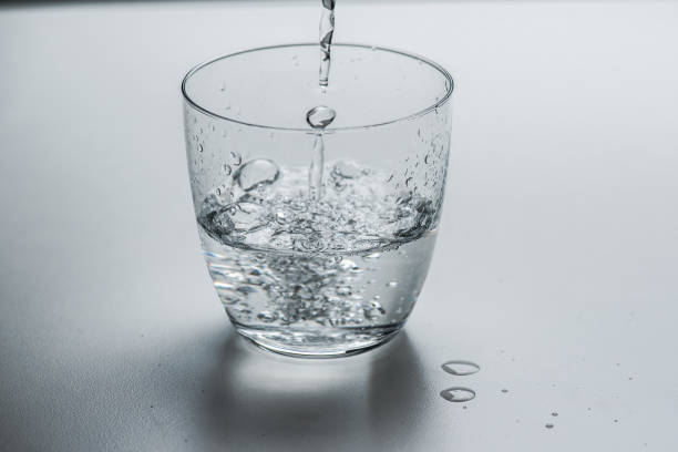 istock glass with water on a white background 1183215769
