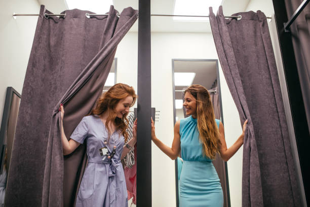 Wow, you look so good! Photo of two young women in the fitting room. fitting room stock pictures, royalty-free photos & images