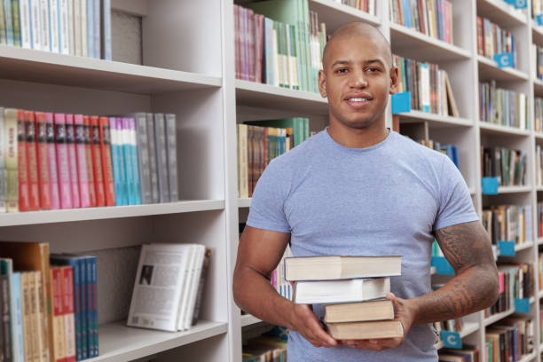 istock Male student at the bookstore or library 1183217485
