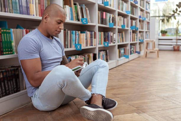 istock Male student at the bookstore or library 1183217660