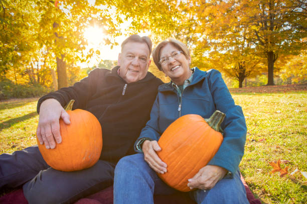 istock Cute Mature Couple With Pumpkins 1183224648