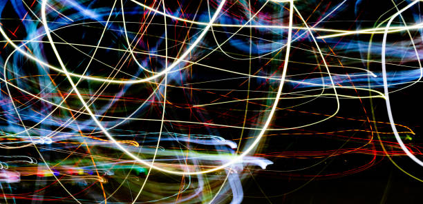 istock Black background with multicolored luminous lines 1183224957