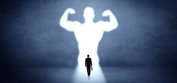 istock Businessman standing in front of a strong hero vision 1183227489