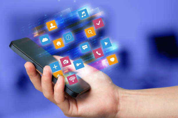 istock Hand using phone with colorful application icons and symbols concept 1183227742