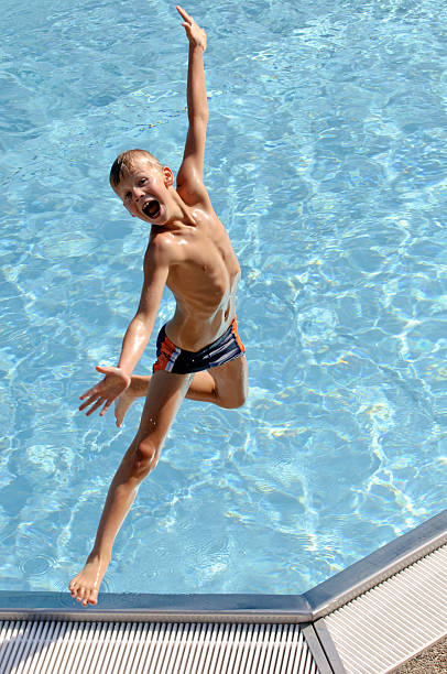 istock Screaming child jumps into the pool 118322808