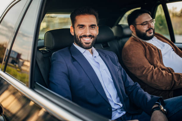 istock Two men driving on the backseat 1183229816