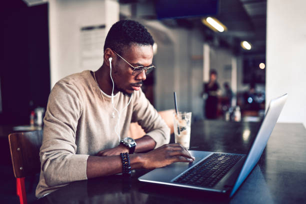 istock African Male Working On Laptop While Enjoying Coffee 1183230994