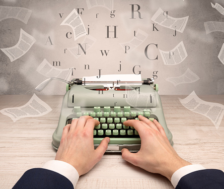 First person perspective hand typewriting with flying documents around